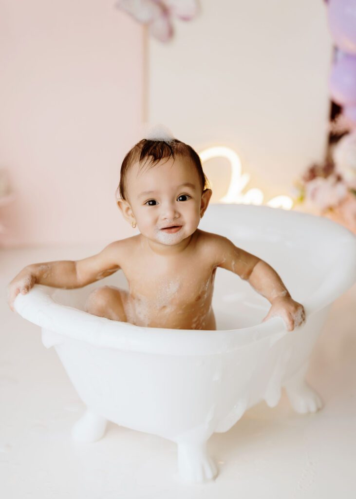 Winnipeg cake smash photographer capturing a baby girl’s first birthday celebration.